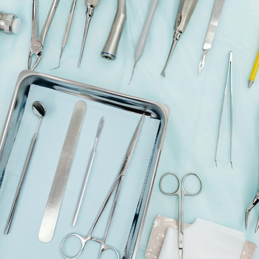 Top view of various dental instruments arranged on a tray, ideal for medical use.