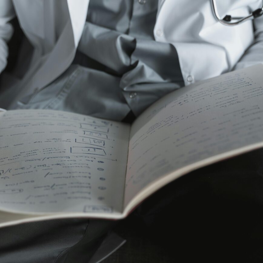 A medical professional reviewing important documents in an office setting.