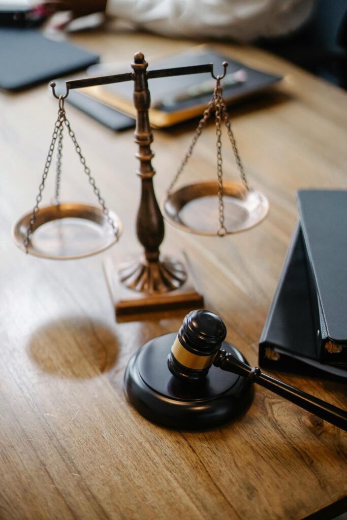 pexels-photo-5669619-5669619-1 A striking image featuring a brass justice scale and gavel on a wooden desk, symbolizing law and justice.